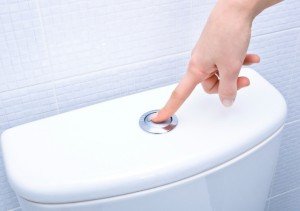 finger pushing button and flushing toilet